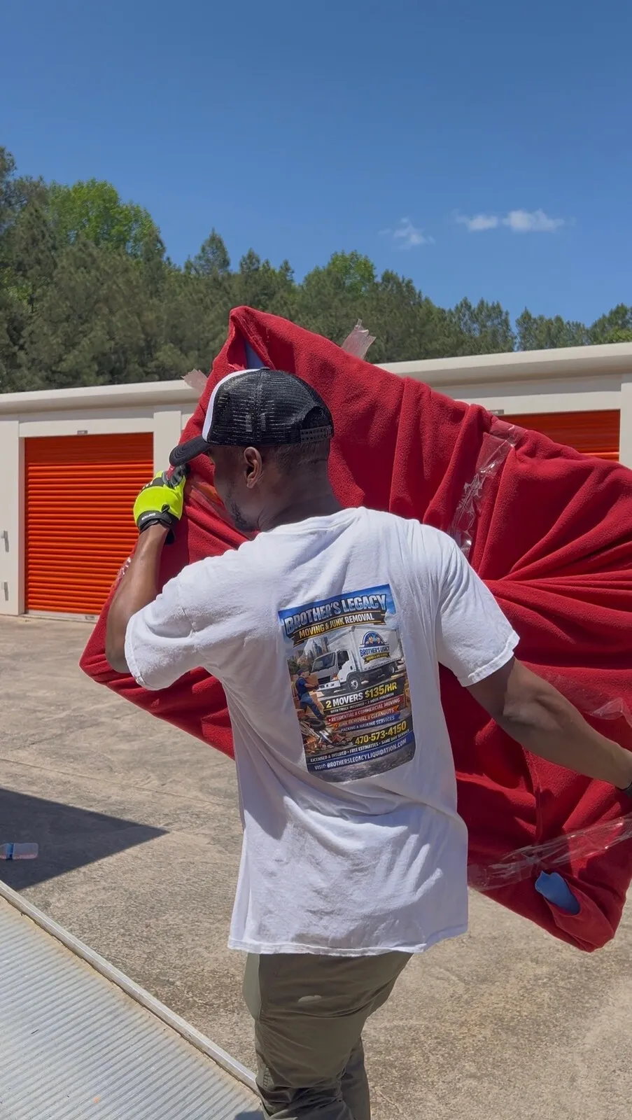 A crew member carrying furniture